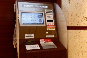 an atm machine with a smart exchange sign on it at Hotel JAL City Naha in Naha