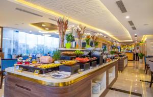 a buffet line with food on display in a restaurant at Grand Gold Hotel in Danang