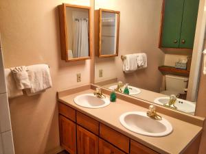 a bathroom with two sinks and a mirror at Right on Main St Hot Tub Close to Marina Garage in Frisco