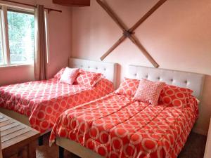 a bedroom with two beds with red and white sheets at Right on Main St Hot Tub Close to Marina Garage in Frisco