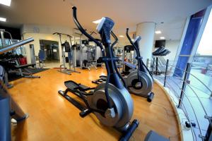 a gym with several exercise bikes in a room at High Point Serviced Apartment in Surabaya