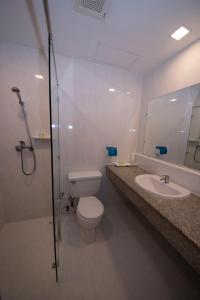 a bathroom with a toilet and a sink and a shower at Panorama Hotel in Yangon