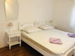 a bedroom with a bed with a mirror and a table at Guest House Marija in Bol