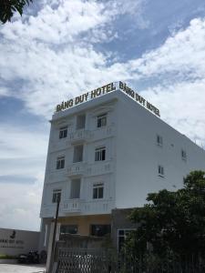a white hotel with a sign on the top of it at Dang Duy Hotel in Lagi