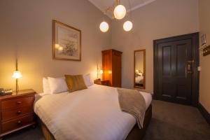 Postel nebo postele na pokoji v ubytování Vue Grand Hotel