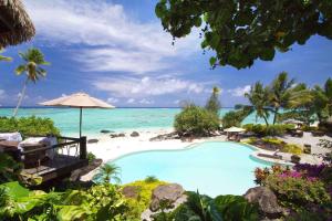 a resort with a swimming pool on the beach at Pacific Resort Aitutaki - Adults Only in Arutanga