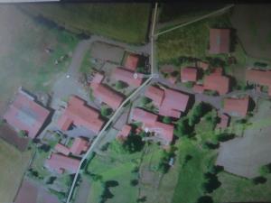 an overhead view of a group of houses with pink roofs at Gite familial à proximité d'une mini ferme in Saint-Haon +7 photos