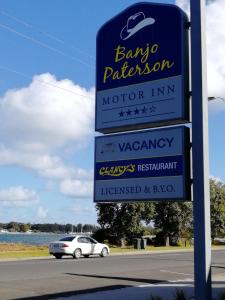 a sign for a car dealership on the side of the road at Banjo Paterson Motor Inn in Lakes Entrance