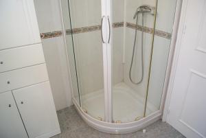 a shower with a glass door in a bathroom at Playa Delicias in Águilas +19 photos