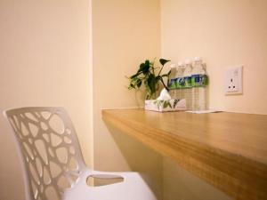 a white chair sitting in front of a wooden counter at 118 Hotel,Dato Keramat - Self Check In in George Town