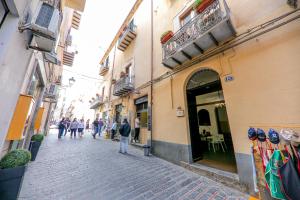 a group of people walking down a street at Madonie Holidays in Cefalù