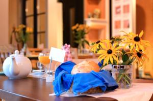 a table with a basket of food and flowers on it at Gästehaus Im Tal 18 in Hellenthal +11 photos