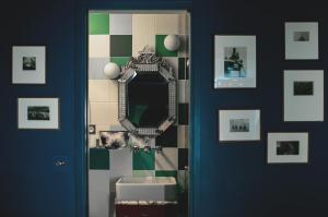 a bathroom with a toilet and a mirror at Hôtel Crayon by Elegancia in Paris