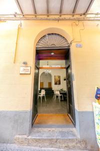 an open door of a building with a table and chairs at Madonie Holidays in Cefalù