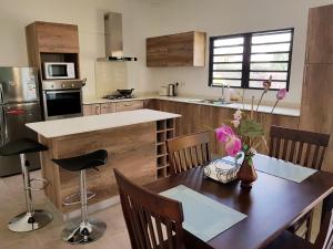 a kitchen with a wooden table and a dining room at La Maison d'Isa in Albion