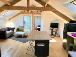 a kitchen and living room with a loft at Le Loft in Lacanau