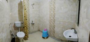 a bathroom with a shower with a toilet and a sink at Su- Koon Homestay in Agra