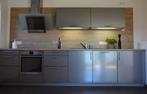 a kitchen with stainless steel appliances and a counter at Chiemsee-Edelweiß Ferienwohnung in Prien am Chiemsee +16 photos