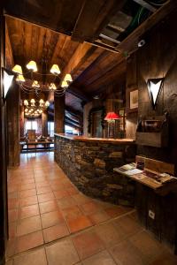 a lobby with a stone wall and a bar at Travelski Home Premium - Résidence Chalets Altitude & Ours 5 stars in Arc 2000