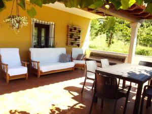 een patio met stoelen en een tafel en stoelen bij O Cruceiro in Lires