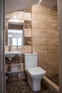 a bathroom with a toilet and a sink at Olympic Coast in Olympic Beach