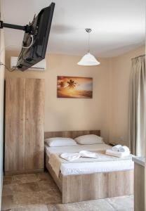 a bedroom with a bed and a tv on the wall at Olympic Coast in Olympic Beach