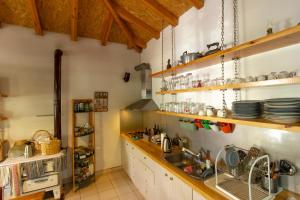 a kitchen with a sink and a counter at Himara Hostel in Himare