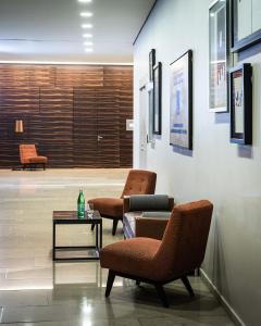 a waiting room with two chairs and a table at AMERON Köln Hotel Regent in Cologne +51 photos