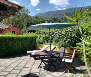 a table and chairs with an umbrella on a patio at Rural Las Llanadas in Los Realejos