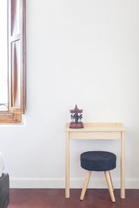 a wooden table with a blue stool next to a desk at Gianburrasca in Florence
