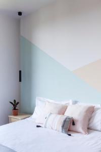 a white bed with white pillows on it at Gianburrasca in Florence +10 photos
