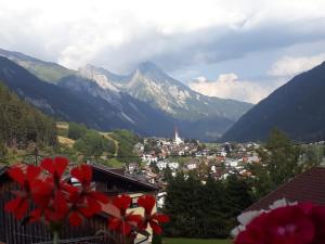 a town in a valley with mountains in the background at Haus Morgensonne in Pettneu am Arlberg