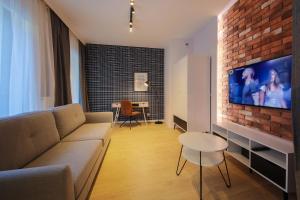 Televízia a/alebo spoločenská miestnosť v ubytovaní Boogie Apartments