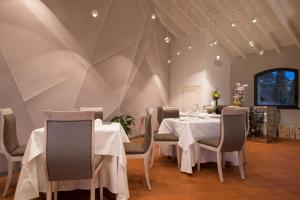 a dining room with a white table and chairs at Locanda La Fortezza in Finale Ligure