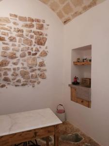 a corner of a room with a stone wall at L' Edera in Fasano