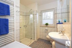 a bathroom with a shower and a toilet and a sink at Haus Seeschwalbe in Ostseebad Karlshagen