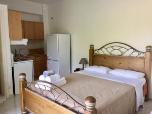 A bed or beds in a room at Anastasios Olive Garden Apartments