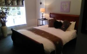 a bedroom with a large bed with a window at The Boathouse in Sutton Bridge