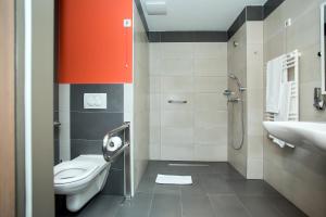 a bathroom with a toilet and a sink at Best Western Plus Lakeside Hotel in Székesfehérvár