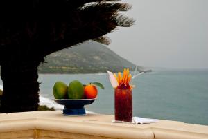 a table with a bowl of fruit and a vase of fruit at Anassa in Polis Chrysochous