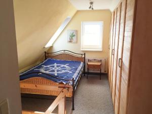 a bedroom with a bed with a blue comforter at Ferienwohnung Am Müritz Seeufer in Waren