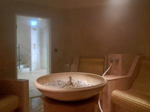 a bathroom with a sink and a bath tub at Castello di Velona - The Leading Hotels of the World in Montalcino