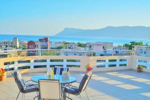a patio with a table and chairs on a balcony at Kissamos View Apartment in Kissamos