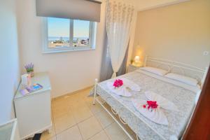 a bedroom with a bed with pink flowers on it at Kissamos View Apartment in Kissamos