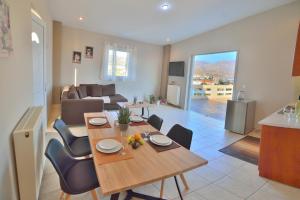 a dining room and living room with a table and chairs at Kissamos View Apartment in Kissamos