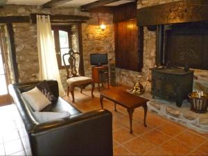 a living room with a couch and a wood stove at La Belle Grange Bussiere in Bussière-Portevine