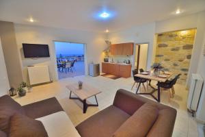 a living room with a couch and a table at Kissamos View Apartment in Kissamos