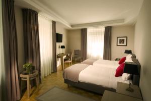 a hotel room with a large bed and a large window at B&B Slamič in Ljubljana