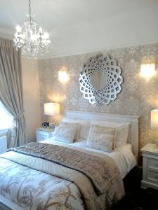 sypialnia z łóżkiem z lustrem na ścianie w obiekcie Aaran Lodge Guest House w Edynburgu