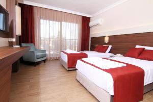 Postel nebo postele na pokoji v ubytování Sunway Club Otel